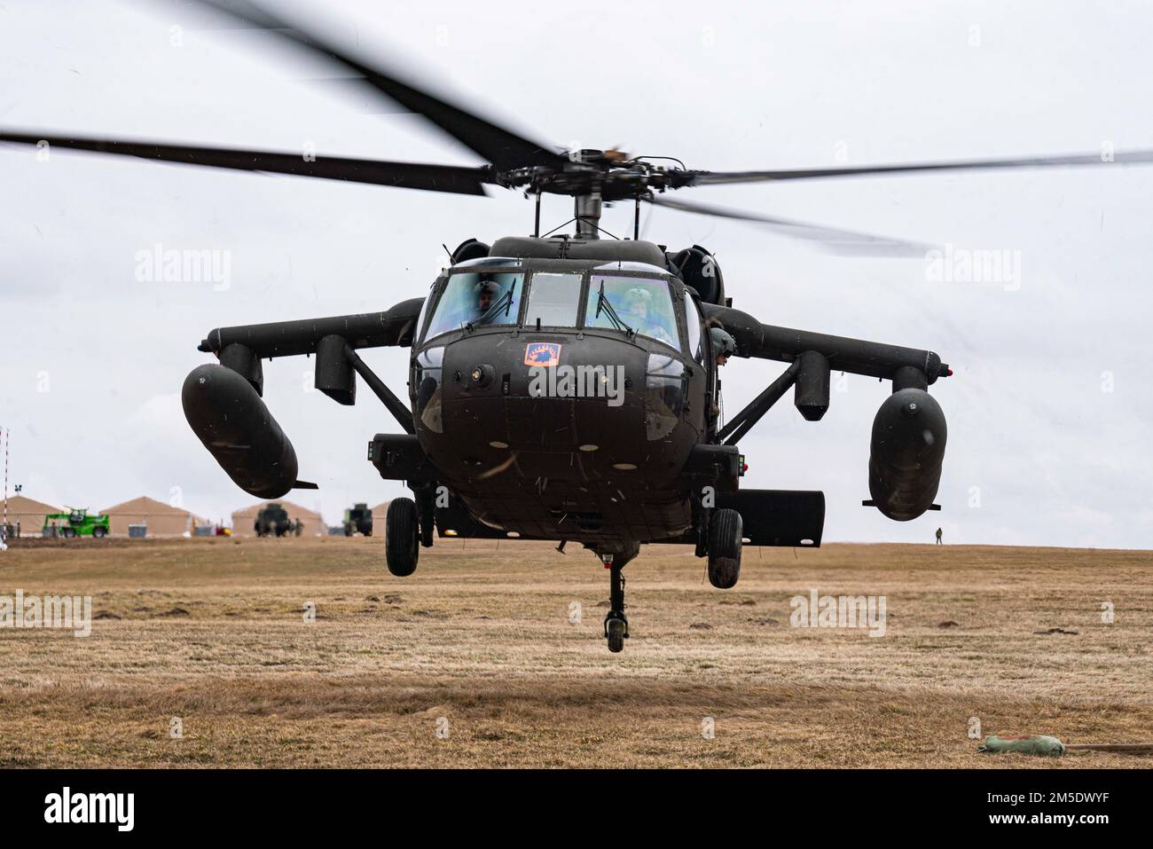 A U.S. Army UH-60 Black Hawk helicopter lands in order to refuel at a refueling point in Zamosc, Poland, March 5, 2022. Thousands of Soldiers from America's Contingency Corps are deployed across Europe where we stand in solidarity with our Allies. Stock Photo