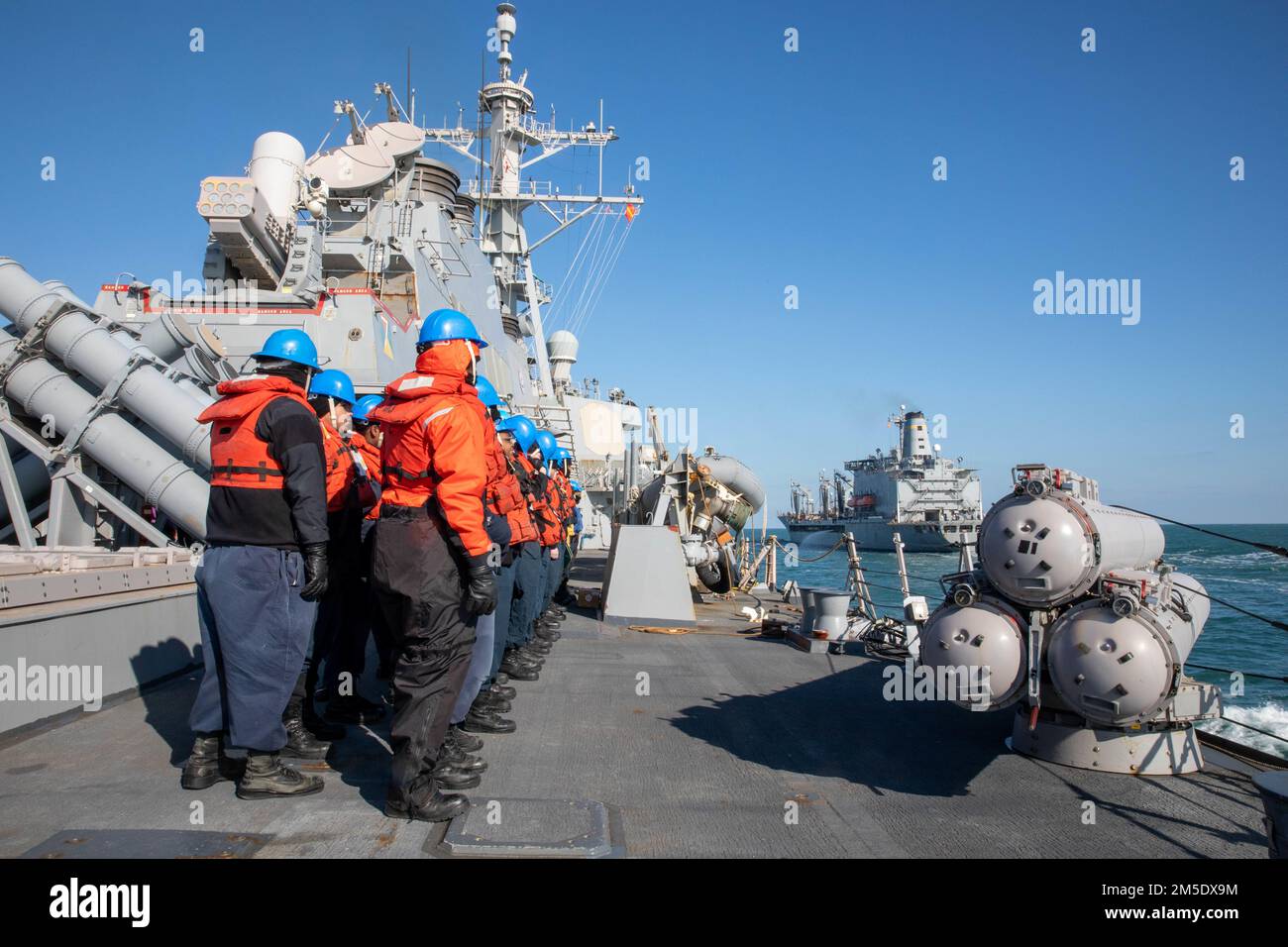 NORTH SEA (March 5, 2022) — Sailors assigned to the guided-missile destroyer USS Donald Cook (DDG 75), prepare for a replenishment at sea (RAS) with USNS Patuxent (T-AO-201), March 5. Donald Cook is deployed to the European theater of operations and participating in a range of maritime activities in support of U.S. Sixth Fleet and NATO Allies. Stock Photo