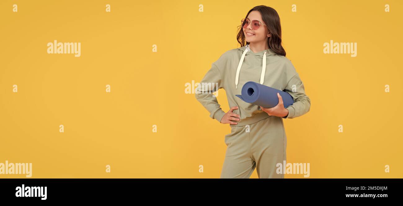 full length of happy child in sportswear and sunglasses with fitness mat. fit your body. Horizontal poster of isolated child face, banner header, copy Stock Photo