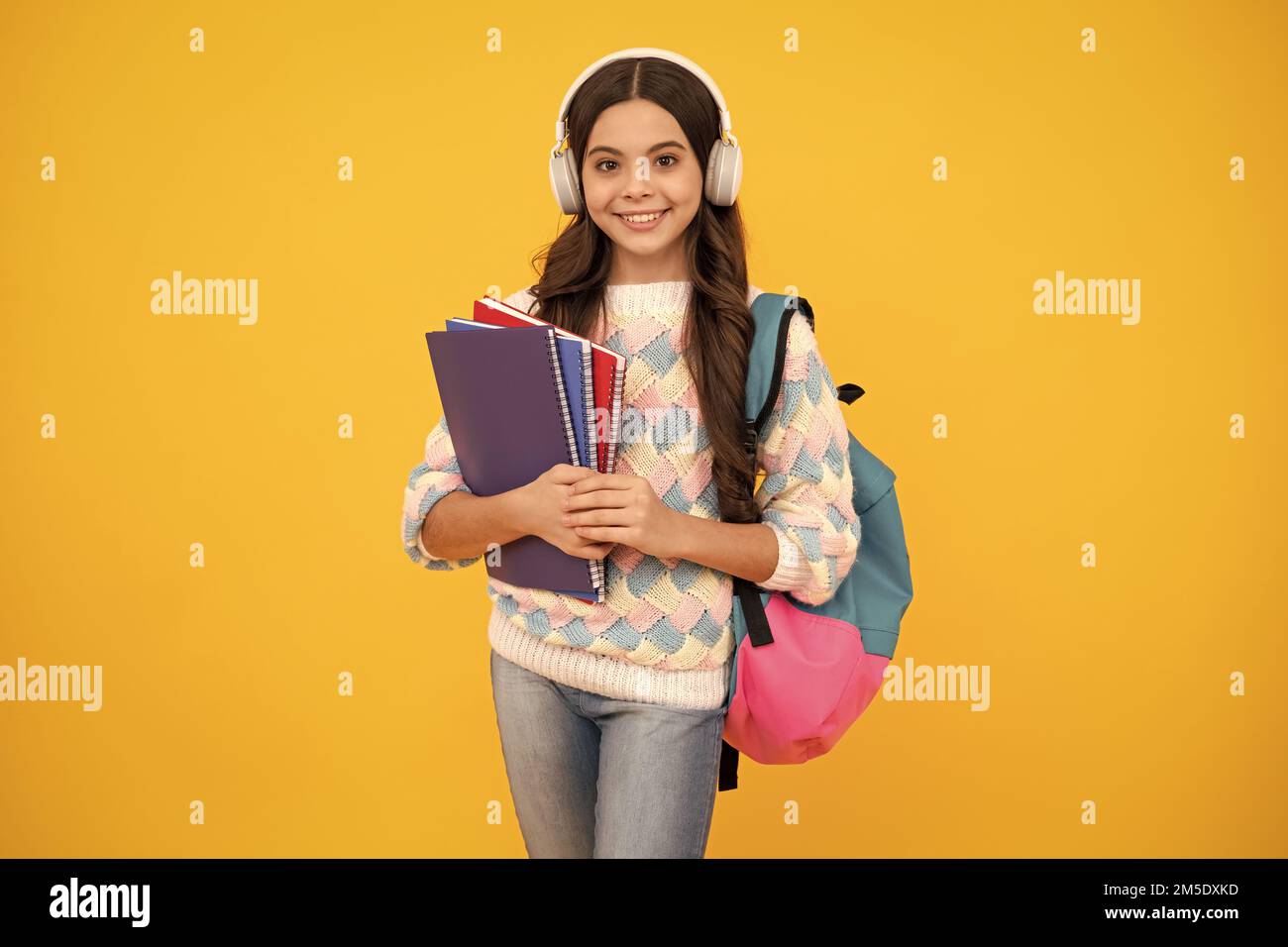 Back to school. Schoolgirl student in headphones with school bag ...