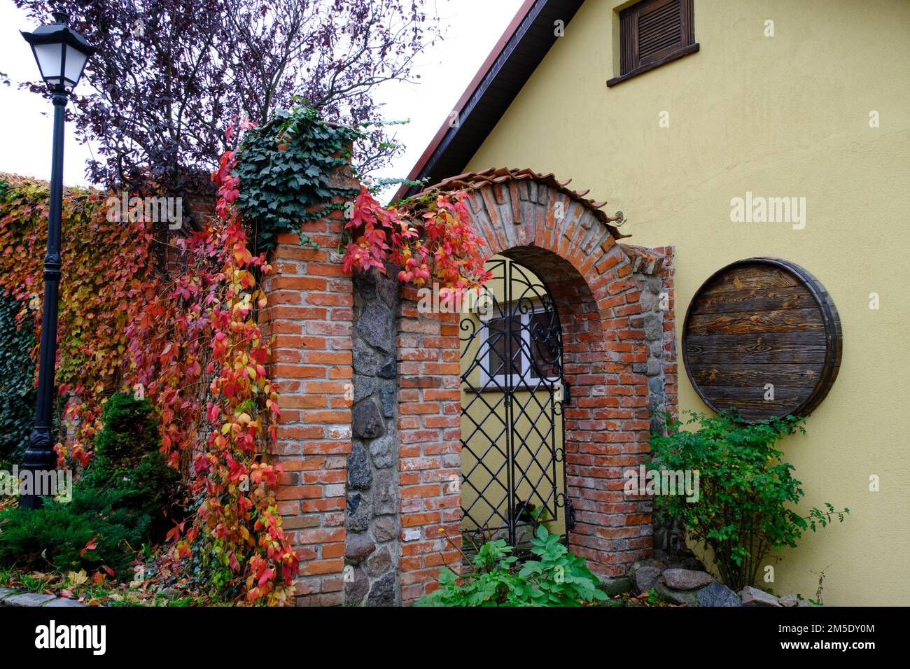 Cozy courtyard with arched passage made red brick Stock Photo - Alamy
