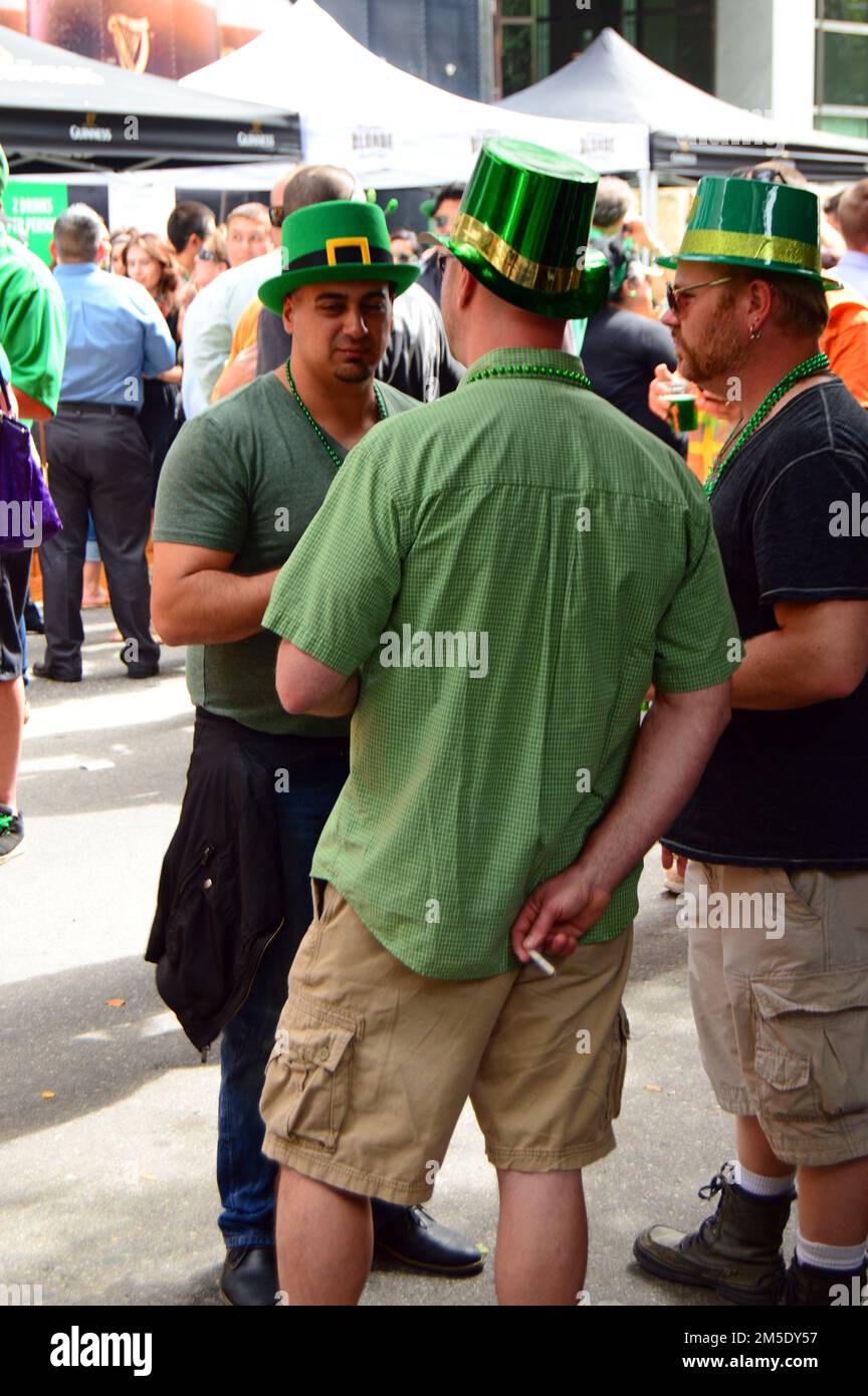 Friends celebrate St Patrick’s Day wearing green at a street party of Irish American pride Stock Photo