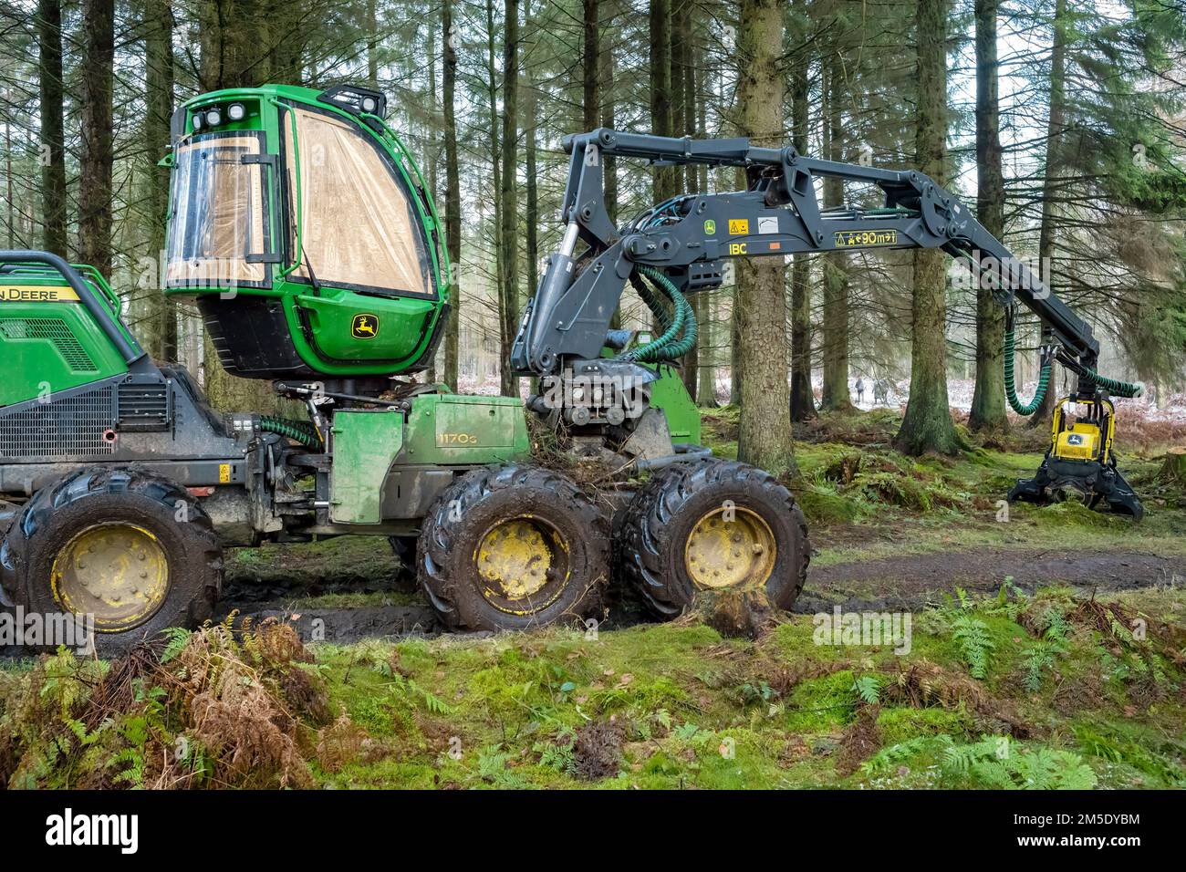 The logging cabin, boom and harvester head of a John Deere logging machine at rest on Boxing Day, 2022. Stock Photo