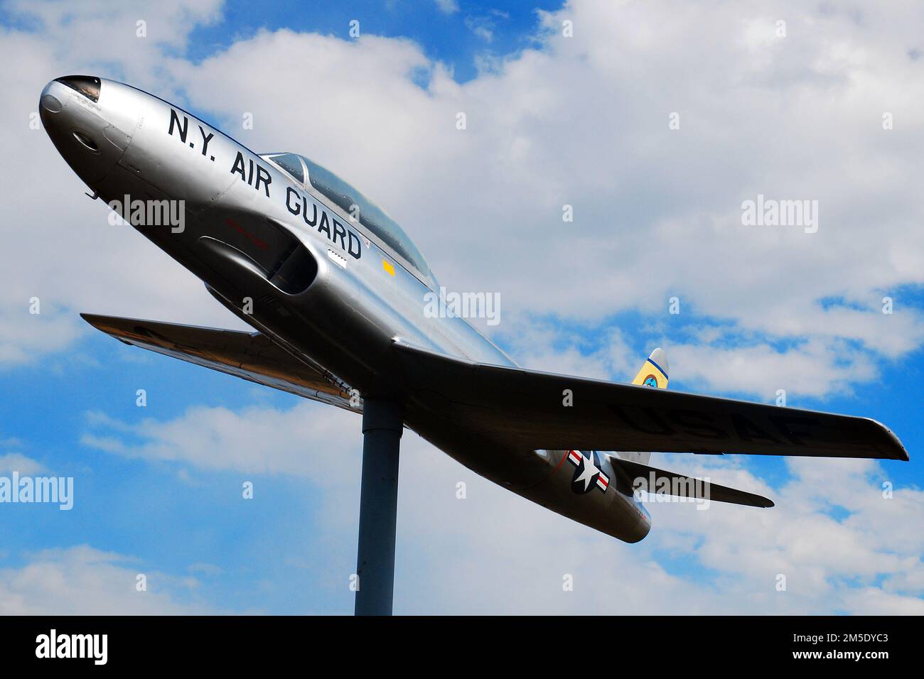 A Lockheed T33 jet fighter, also known as Plane on a Stick, stands at the entrance of the Westchester County Airport Stock Photo