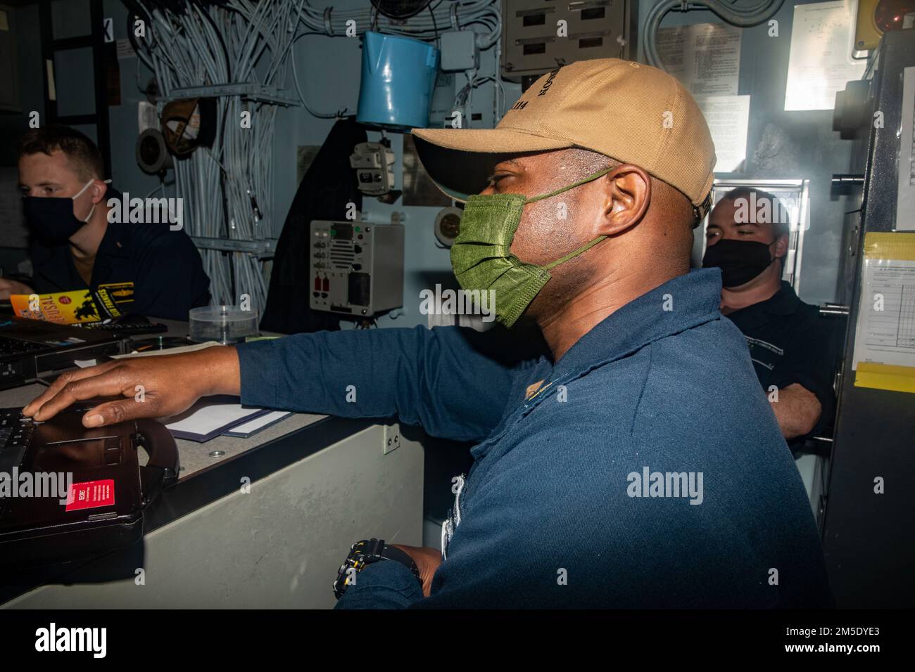 PHILIPPINE SEA (March 5, 2022) Sailors work on the captain’s night orders aboard Arleigh Burke-class guided-missile destroyer USS Ralph Johnson (DDG 114). Ralph Johnson is assigned to Task Force 71/Destroyer Squadron (DESRON) 15, the Navy’s largest forward-deployed DESRON and the U.S. 7th fleet’s principal surface force. Stock Photo