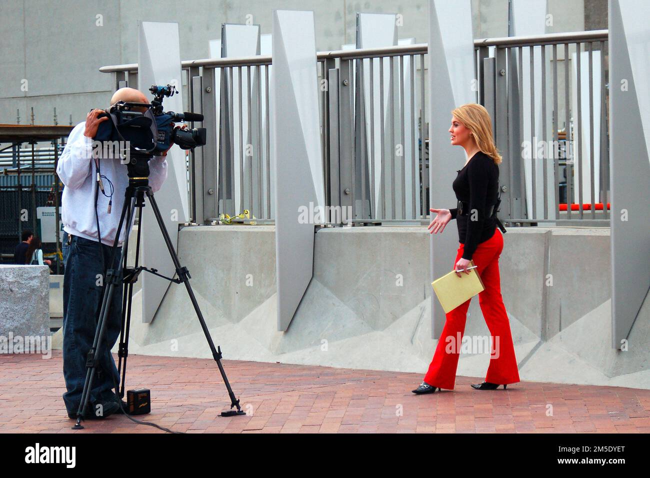 A newswoman reports live on camera as part of the broadcast media Stock Photo