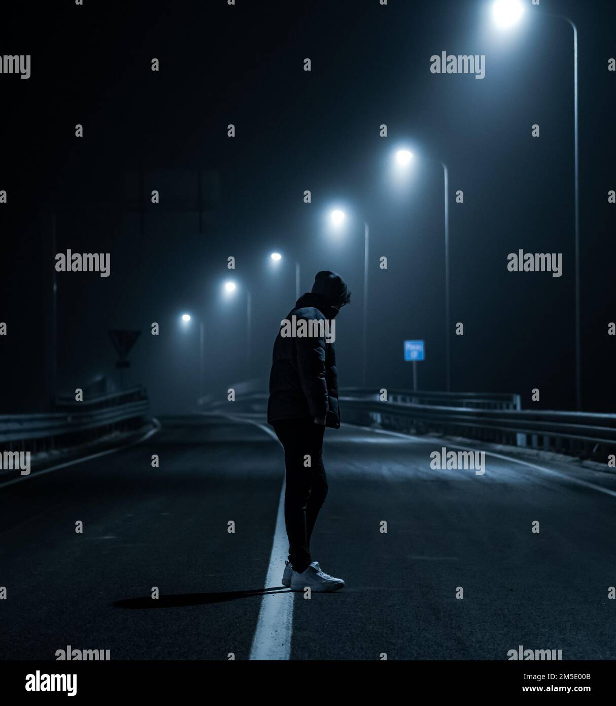 Man alone standing empty road hi-res stock photography and images - Alamy