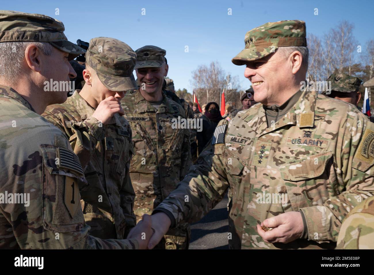 U.S. Army Gen. Mark A. Milley (right), Chairman of the Joint Chiefs of Staff, prepares to hand a coin to Command Sgt. Maj. Robert N. Christensen, command sergeant major of 1-3rd Attack Battalion, 12th Combat Aviation Brigade at Camp Adazi, Latvia, on March 5, 2022. Milley, the highest-ranking U.S. military leader, was joined by United States Ambassador to Latvia John Carwile, Latvian Lt. General Leonīds Kalniņš, Chief of Defense, and Gen. Christopher G. Cavoli, Commanding General of U.S. Army Europe and Africa, for the visit to U.S. and Latvian soldiers. Milley said that recent U.S. troop depl Stock Photo