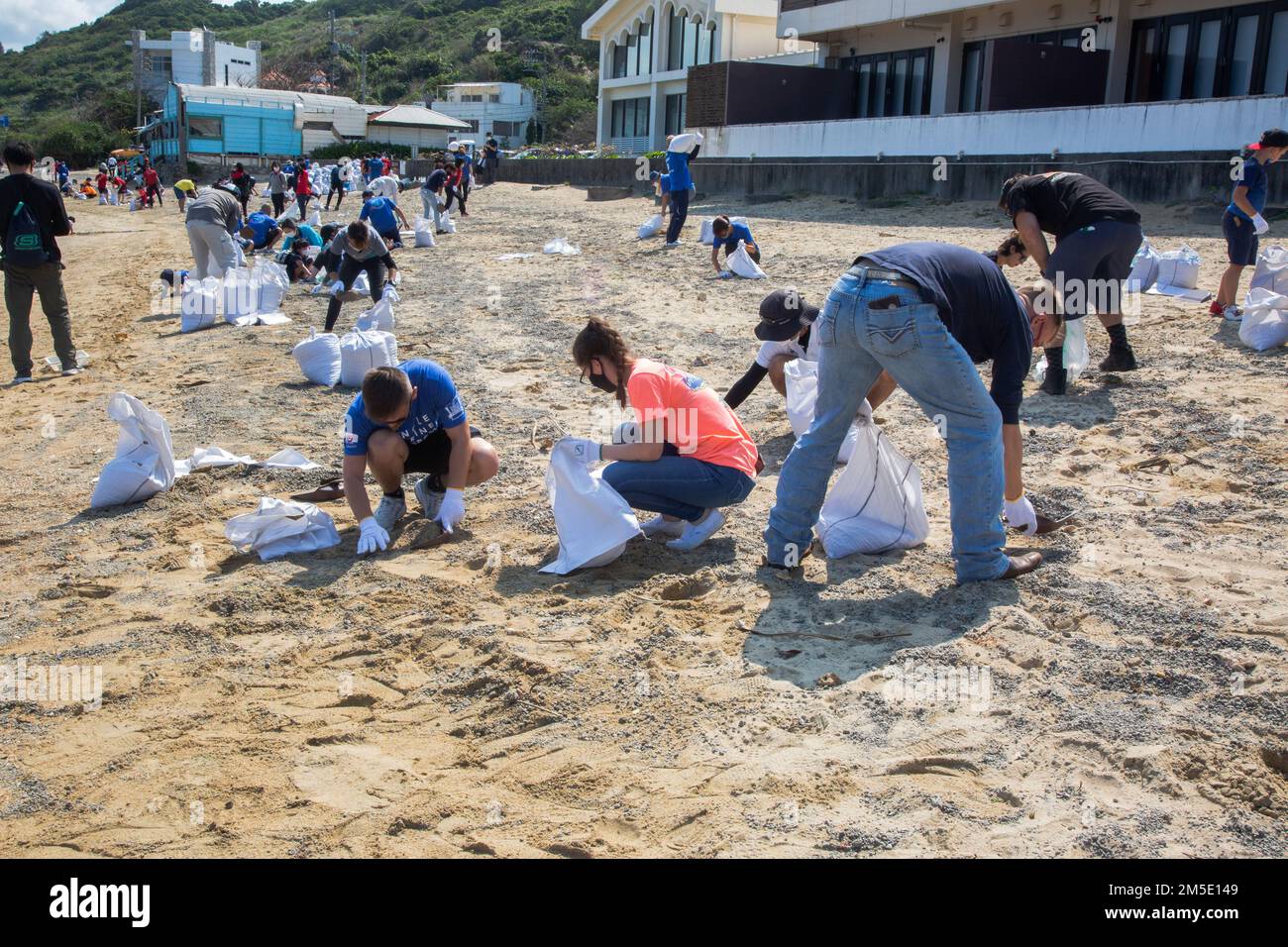 Single Marine Program members experience pumice stone removal for the first time at Kuraha Beach, also known as Malibu beach, in Onna village. Stock Photo