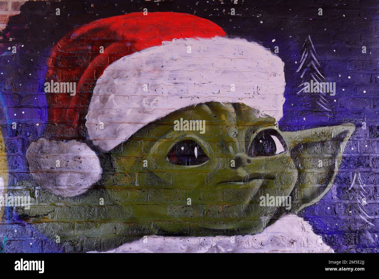 A close up of a Christmas Star Wars mural in Leeds featuring Yoda in a Santa hat. Created by artist Laffiti & Northern Mural Co Stock Photo