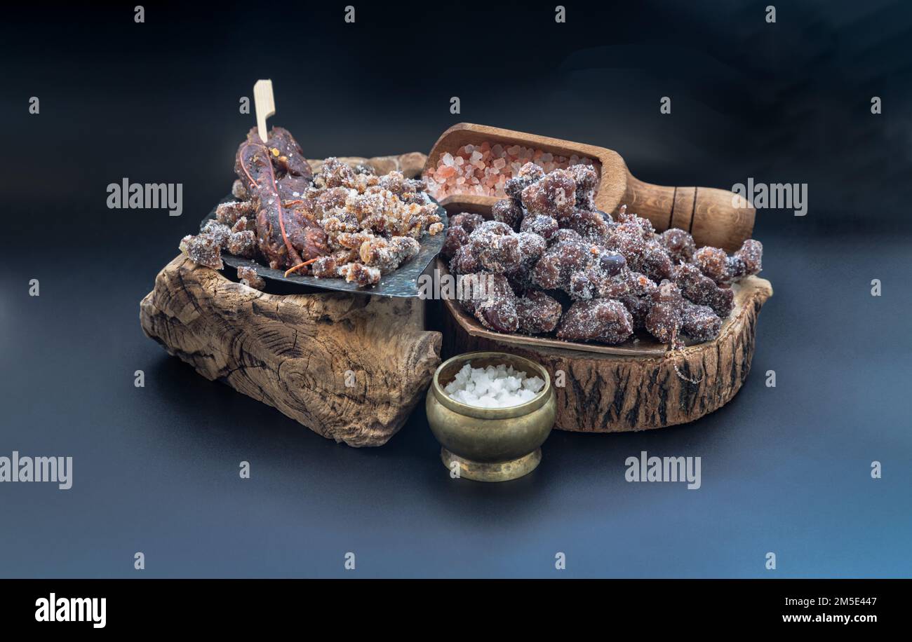 Sweet tamarind seasoned with Sweet and sour taste lay on the wood log slices sprinkler with Himalayan salt, Enjoy snacking when feel exhausted on dark Stock Photo