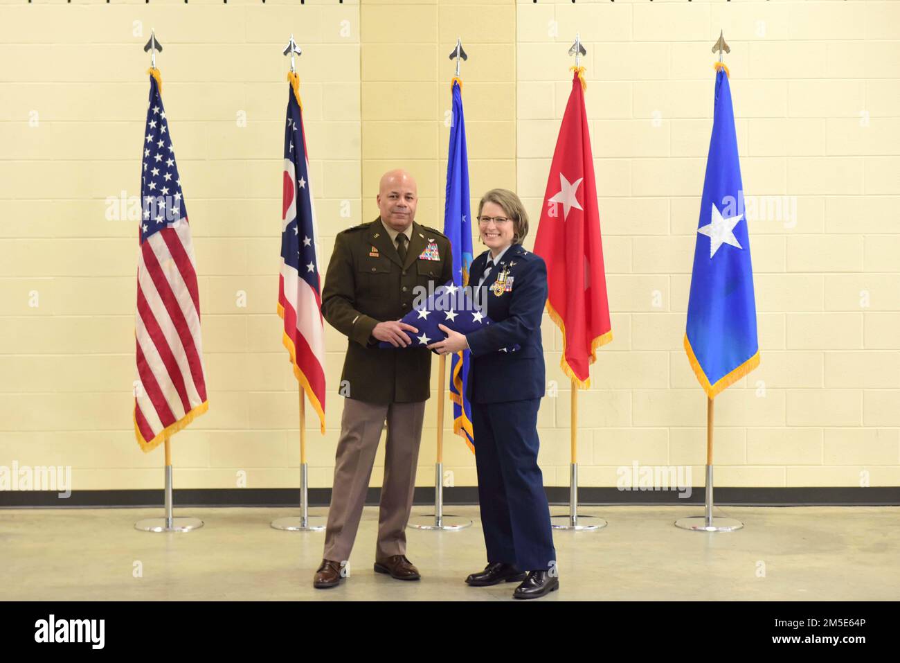 Major Gen. John C. Harris, Jr., Ohio adjutant general, presents Brig. Gen. Rebecca O'Conner with a flag during her retirement ceremony March 6, 2022 at the 178th Wing in Springfield, Ohio(Air National Guard photo by Airman Colin Simpson) Stock Photo
