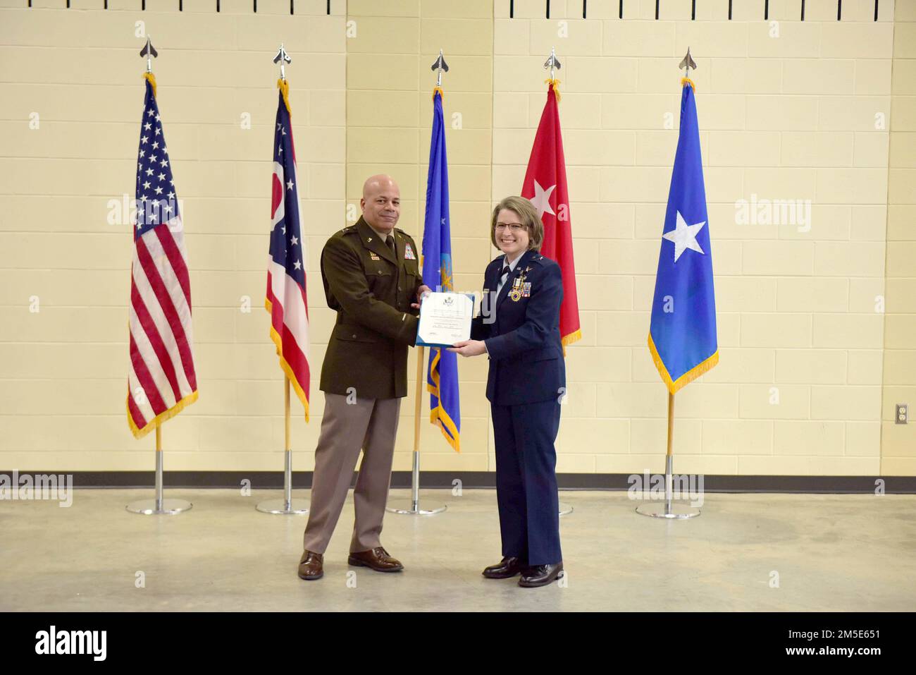 Major Gen. John C. Harris, Jr., Ohio adjutant general, presents Brig. Gen. Rebecca O'Conner with a certificate of retirement during a ceremony March 6, 2022 at the 178th Wing in Springfield, Ohio(Air National Guard photo by Airman Colin Simpson) Stock Photo