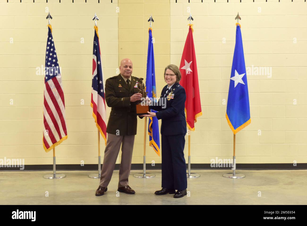 Major Gen. John C. Harris, Jr., Ohio adjutant general, presents Brig. Gen. Rebecca O'Conner with a minuteman statue  during her retirement ceremony March 6, 2022 at the 178th Wing in Springfield, Ohio(Air National Guard photo by Airman Colin Simpson) Stock Photo