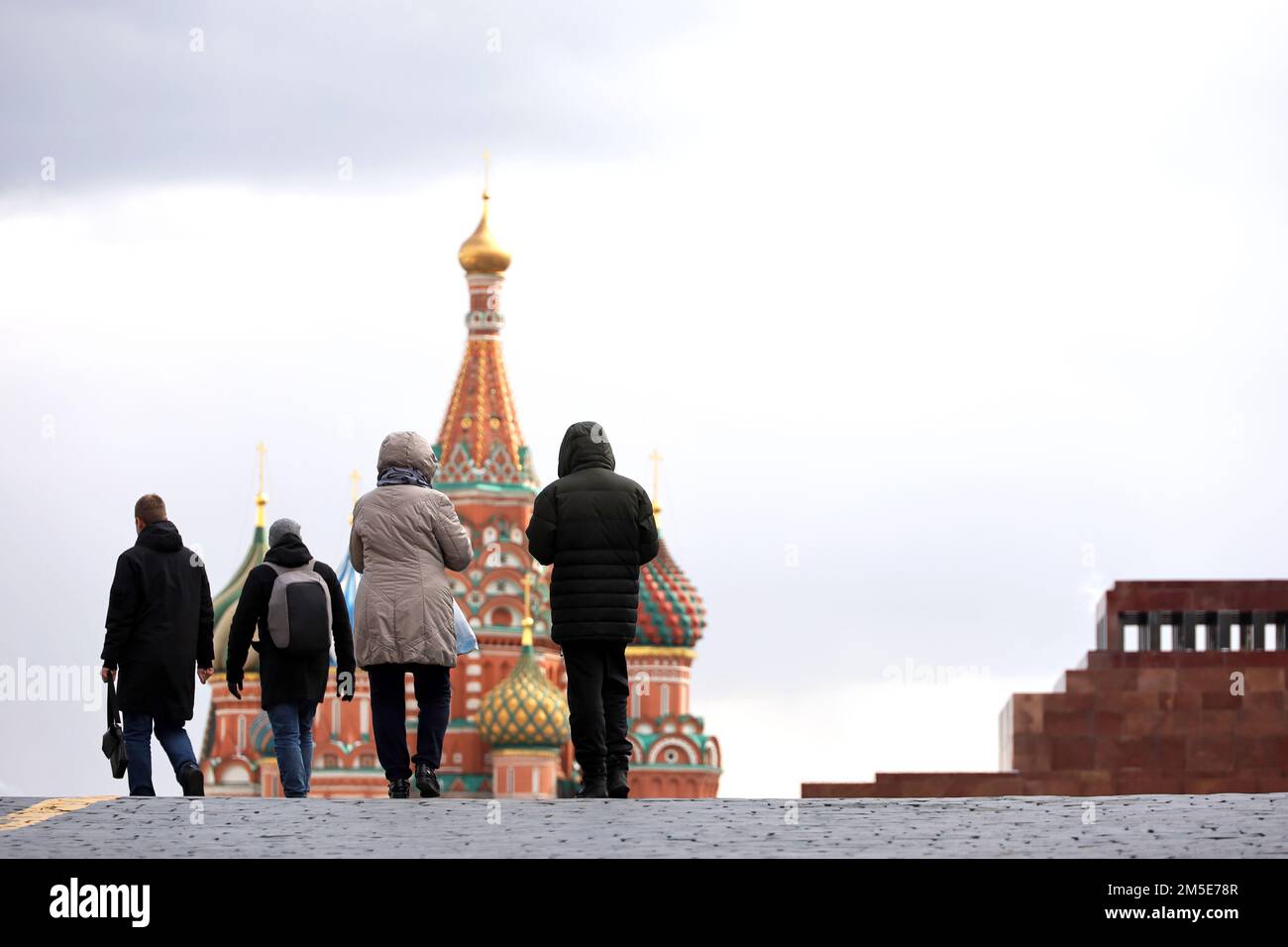 View to Red square in Moscow at winter. People walking on background of St. Basil's Cathedral and Lenin mausoleum Stock Photo
