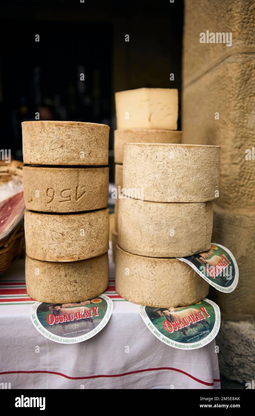 A pile of Ossau-Iraty cheese wheels, a typical basque cheese, in a market. Stock Photo