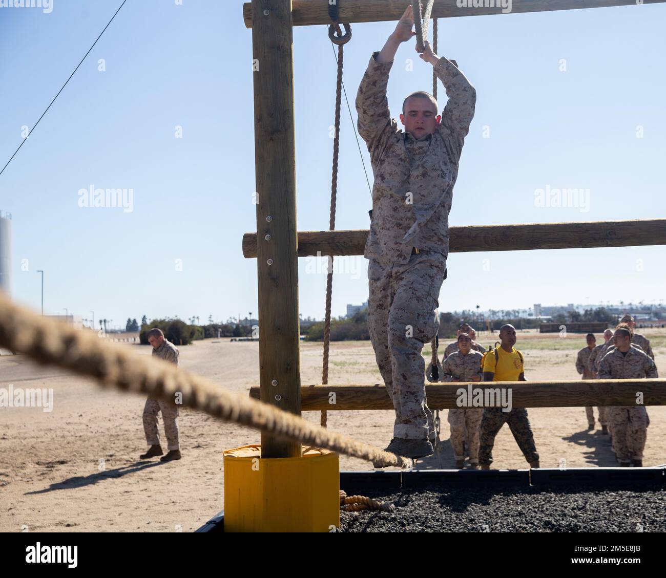 U.S. Marine Corps Recruit Calib A. Lilly, a recruit with Golf Company, 2nd Recruit Training Battalion, navigates the monkey bridge obstacle during the confidence course at Marine Corps Recruit Depot San Diego, March 7, 2022. Recruits became physically and mentally stronger by overcoming obstacles that require strength, balance, and determination. Floyd was recruited out of Wilton, Iowa with Recruiting Substation Cedar Rapids. Stock Photo