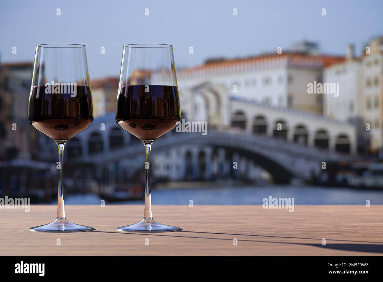 Two glass of red wine on Rialto bridge and Grand Canal background. Stock Photo