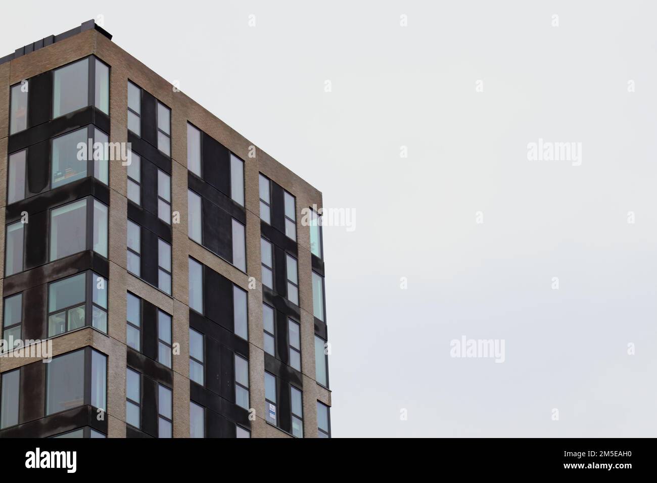 A modern high-rise building with glass windows Stock Photo - Alamy