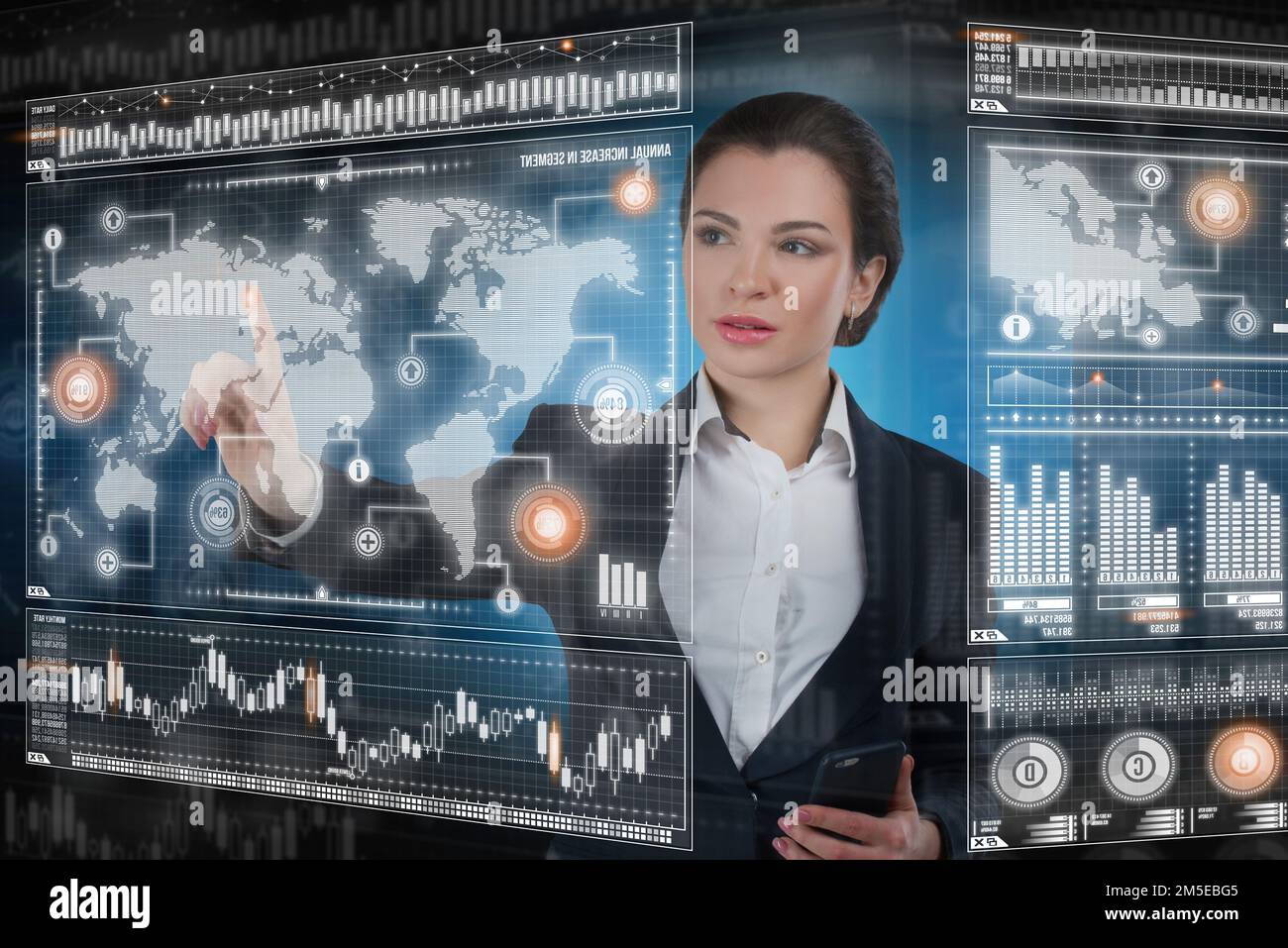 Young business lady works with virtual graphic interface in futuristic office Stock Photo