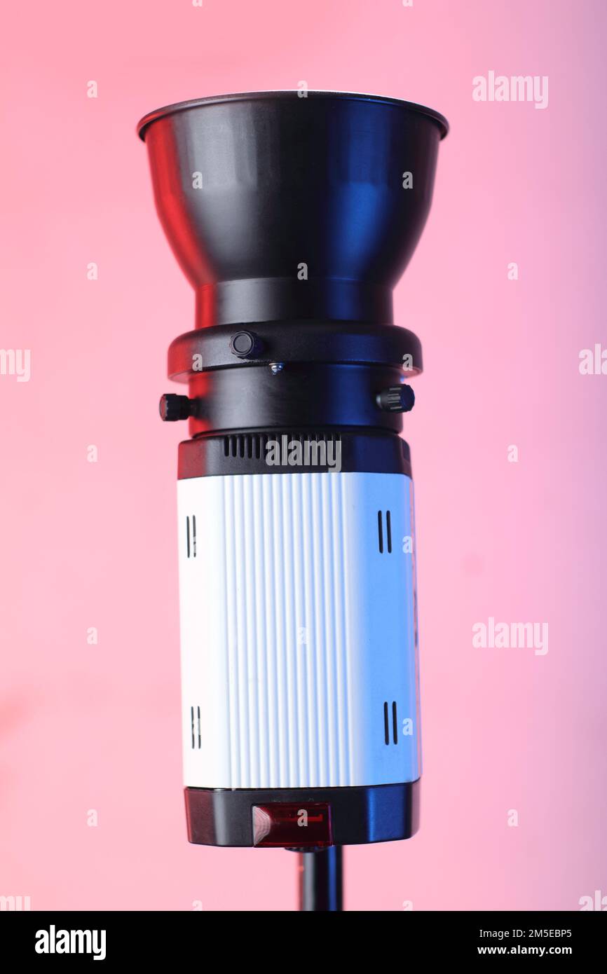 studio flash on a tripod and pink background Stock Photo
