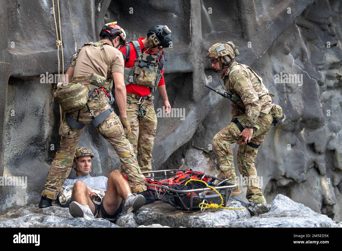 U.S. Air Force pararescuemen from the 31st Rescue Squadron prepare to evacuate an injured victim during medical evacuation training at Okuma Beach, Japan, March 7, 2022. The 31st RQS used this training opportunity to exercise proficiency in medical coordination, evaluation, treatment, and recovery operations at Okuma. Stock Photo