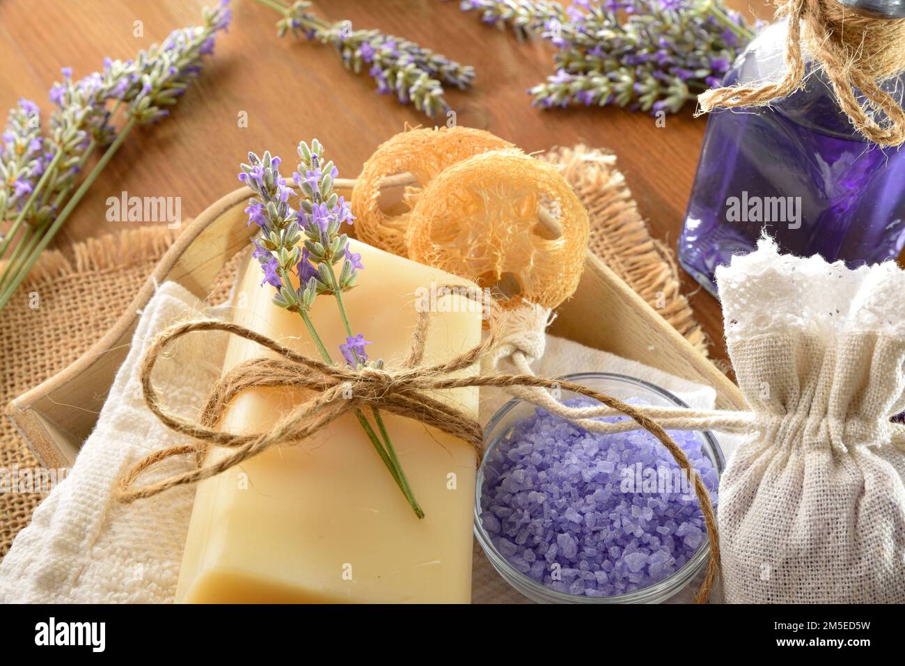 Detail of skin care products with lavender essence on wooden table. Elevated view. Stock Photo