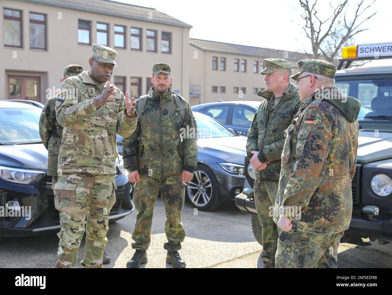 Maj. Gen. James Smith, left, commanding general, 21st Theater Sustainment Command, interacts with Bundeswehr soldiers during operations at Coleman Barracks, Germany on March 7, 2022. Working closely with our Host nation partners enhances interoperability and strengthens our ironclad partnership. Stock Photo