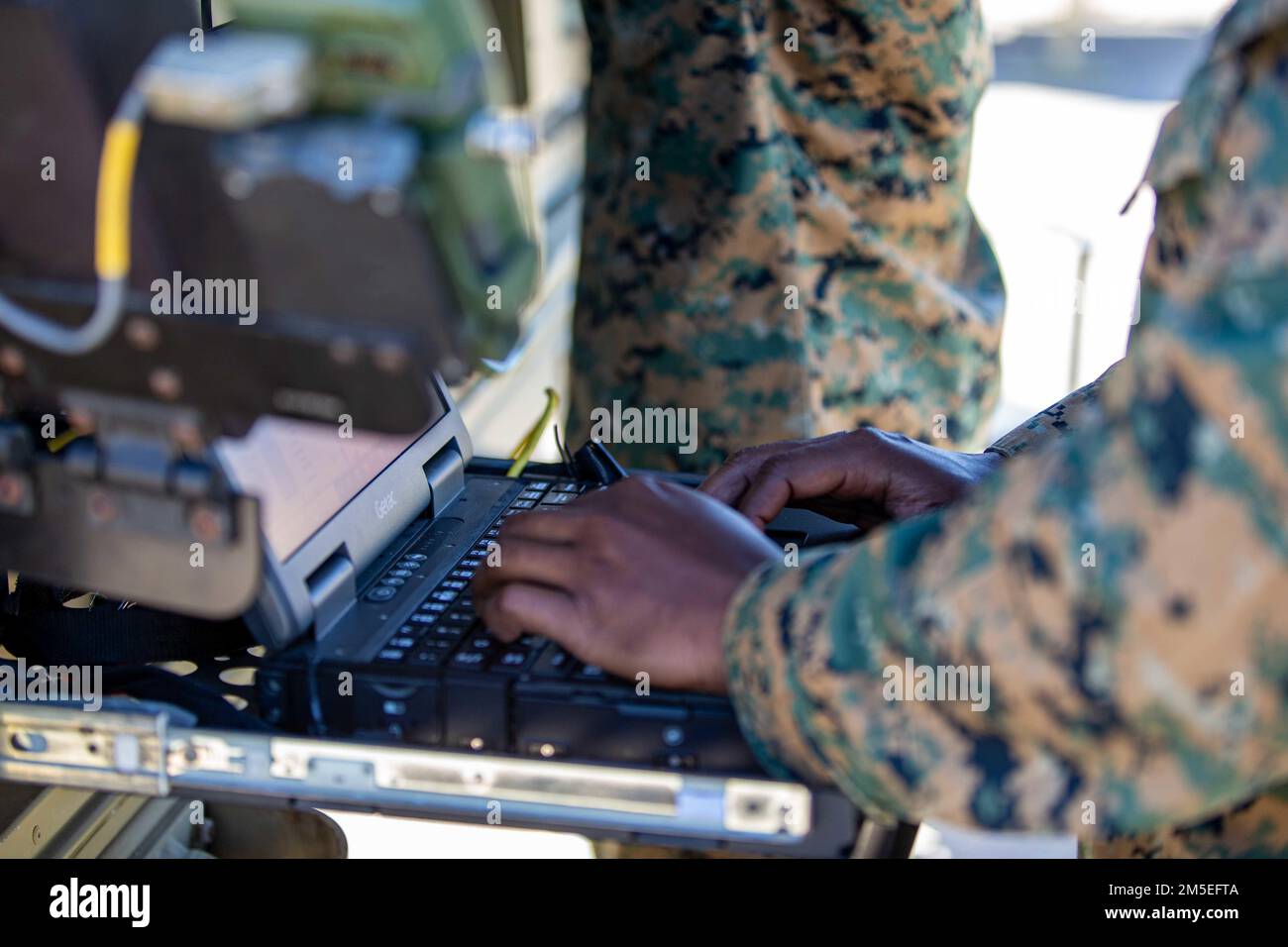 U.S. Marine Corps Cpl. Ahmed Spence, a satellite communications operator with 9th Communication Battalion, I Marine Expeditionary Force Information Group, sets up connection on the Very Small Aperture Terminal at Marine Corps Base Camp Pendleton, California, March 11, 2022. This training allows the 9th Communication Battalion to be capable of operating, defending, and preserving information networks to enable command and control for the commander in all domains, and support and conduct Marine Air Ground Task Force operations in the information environment. Stock Photo