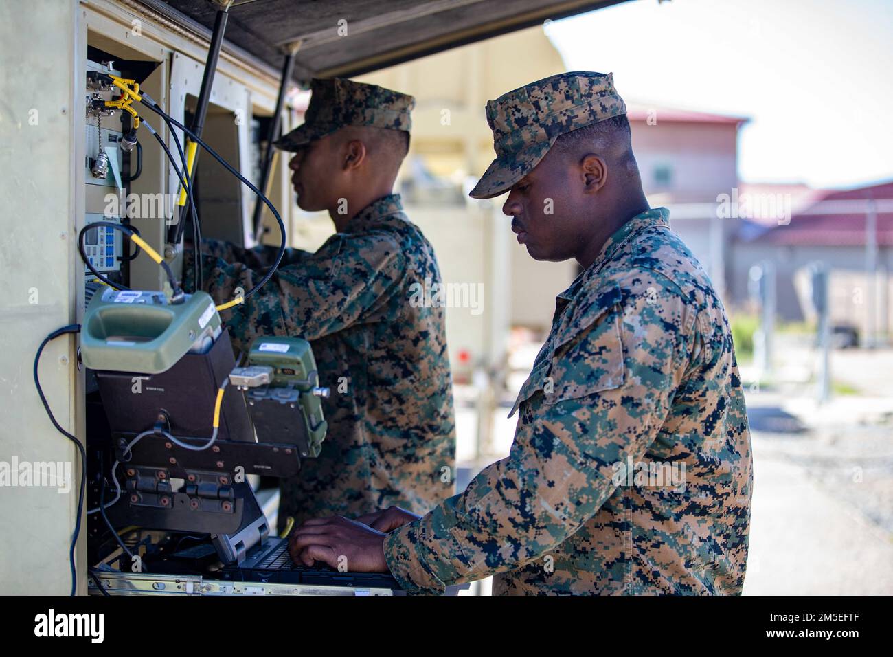 U.S. Marine Corps Cpl Ricardo Aguilar, left and Cpl. Ahmed Spence, right, both satellite communications operators with 9th Communication Battalion, I Marine Expeditionary Force Information Group, sets up connection on the Very Small Aperture Terminal at Marine Corps Base Camp Pendleton, California, March 11, 2022. This training allows the 9th Communication Battalion to be capable of operating, defending, and preserving information networks to enable command and control for the commander in all domains, and support and conduct Marine Air Ground Task Force operations in the information environme Stock Photo