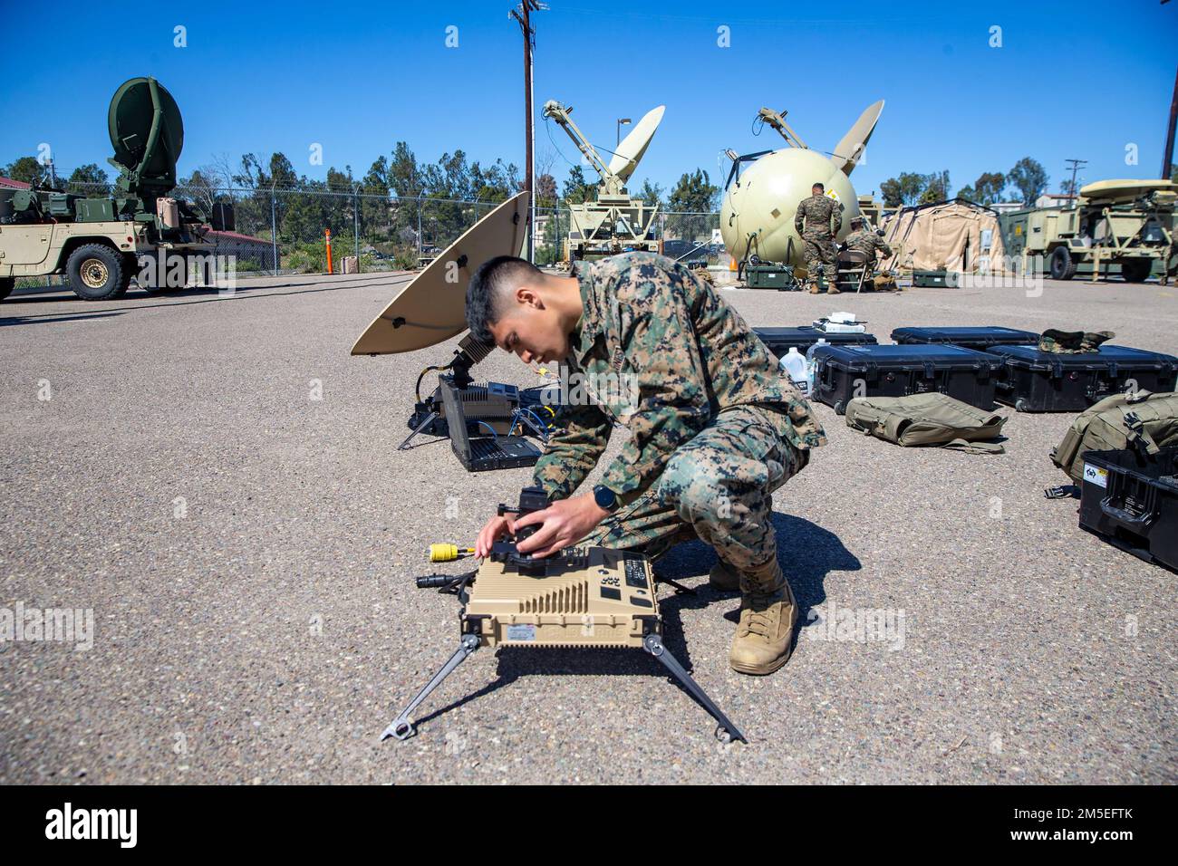 U.S. Marine Corps Lance Cpl. Marvin Diaz, a satellite communications operator with 9th Communication Battalion, I Marine Expeditionary Force Information Group, set up the Marine Corps Wideband Satellite Communications - Expeditionary at Marine Corps Base Camp Pendleton, California, March 11, 2022. This training allows the 9th Communication Battalion to be capable of operating, defending, and preserving information networks to enable command and control for the commander in all domains, and support and conduct Marine Air Ground Task Force operations in the information environment. Stock Photo