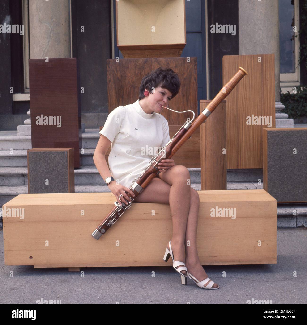 A model poses with a basoon by vintage large speakers. c1970. Photo by Gilbert Adams    From The Gilbert Adams Collection - wholly owned by Tony Henshaw Stock Photo