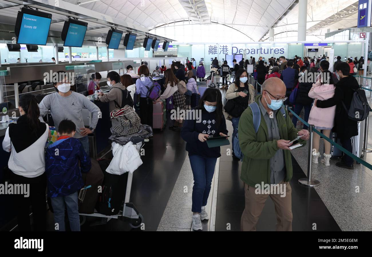 Passengers check in for their flight at the Cathay Pacific Airline Check in counter during the