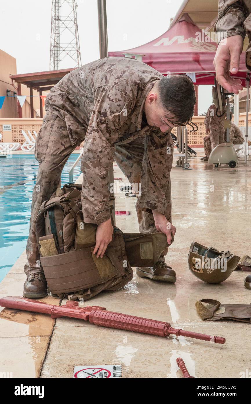 220308-M-AU949-0128 NAVAL SUPPORT ACTIVITY BAHRAIN (Mar. 8, 2022) – A U.S. Marine assigned to Fleet Anti-Terrorism Security Team Central Command (FASTCENT) prepares his gear to conduct Intermediate Swim Qualification onboard Naval Support Activity Bahrain, Mar. 8. FASTCENT provides expeditionary anti-terrorism and security forces to embassies, consulates, and other vital national assets throughout the U.S. Central Command area of responsibility. Stock Photo