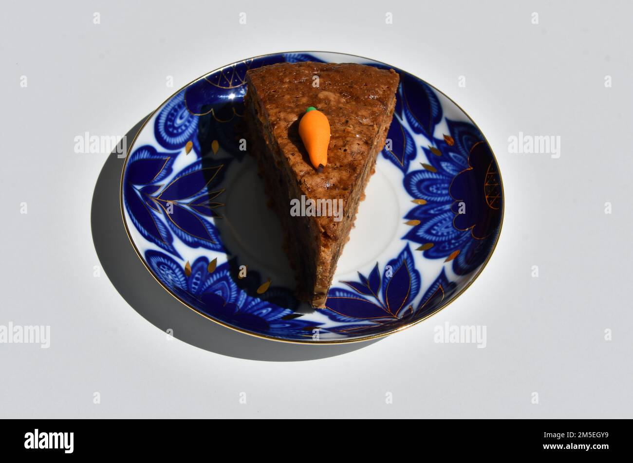 A piece of carrot cake on the coloured plate Stock Photo