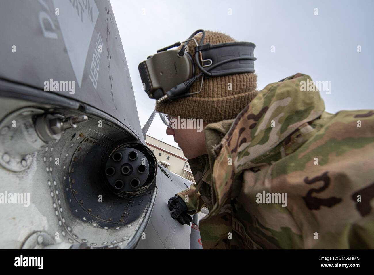 U.S. Air Force Senior Airman Hunter Duby, a weapons loader assigned to the Ohio National Guard’s 180th Fighter Wing, inspects an M61A1 Vulcan Cannon on an F-16 Fighting Falcon, assigned to the 180FW, at Joint Base Elmendorf-Richardson, Alaska, during U.S. Northern Command Exercise ARCTIC EDGE 2022, March 8, 2022.  AE22 is a biennial homeland defense exercise designed for U.S. and Canadian Armed Forces to demonstrate and exercise a joint capability to rapidly deploy and operate in the Arctic. Stock Photo