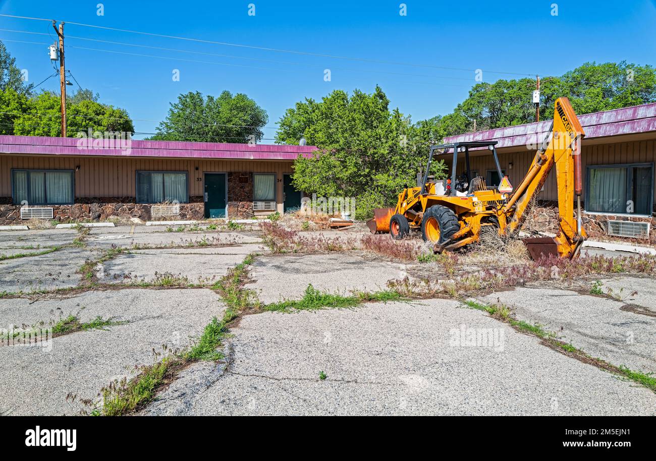 A Case front loader in the overgrown parking lot of an abandoned motel in Wells, Nevada, USA Stock Photo