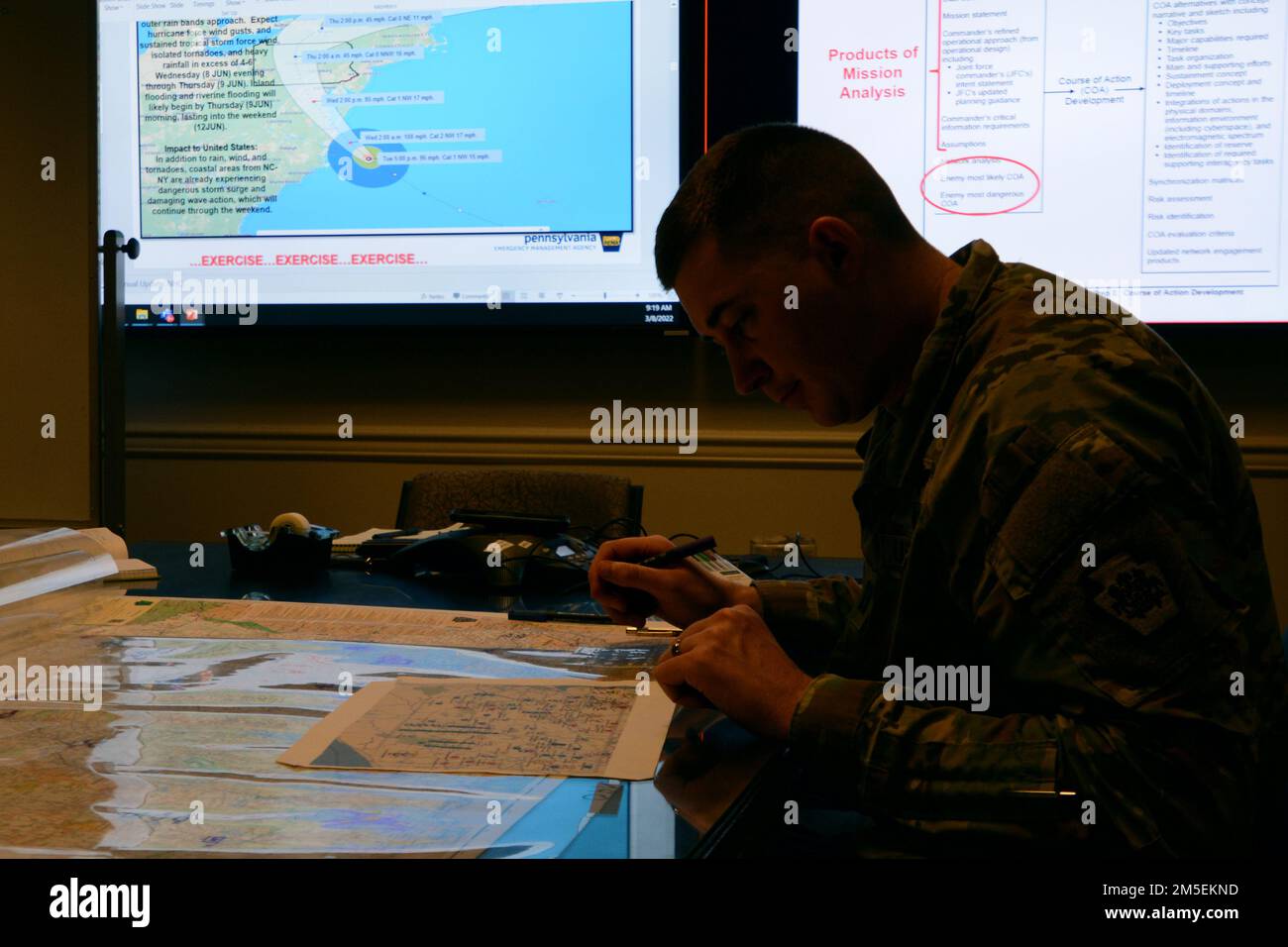 Capt. Brandon Sweeney, current operations officer, Pennsylvania National Guard, marks unit locations on a map of Pennsylvania during a staff training course March 8. The trial course, hosted by U.S. Northern Command, will be the Phase II of the Joint Staff Training Course. The course trained staff on emergency preparedness using a notional Category 2 Hurricane scenario. Stock Photo