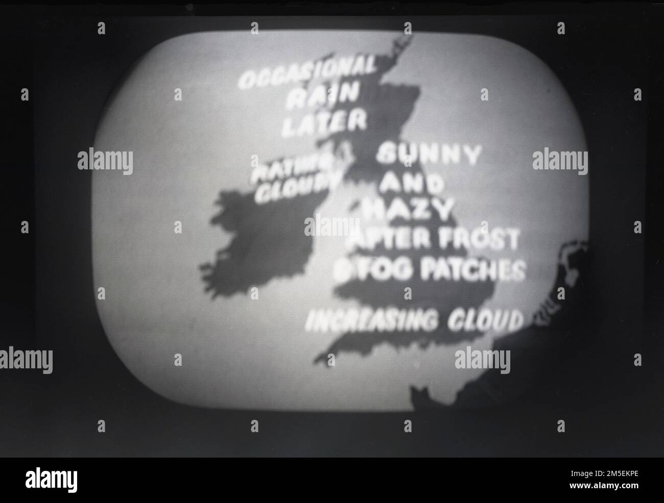 1957, historical, a BBC television in-vision weatherchart or weather forecast. On the screen a simple map of the UK covered with script showing four headlines;. Northern Ireland, Rather Cloudy, Scotland, Occasional Rain Later, Sunny & Hazy After Frost & Fog Patches over Central England and over Southern England, Increasing Cloud. Stock Photo