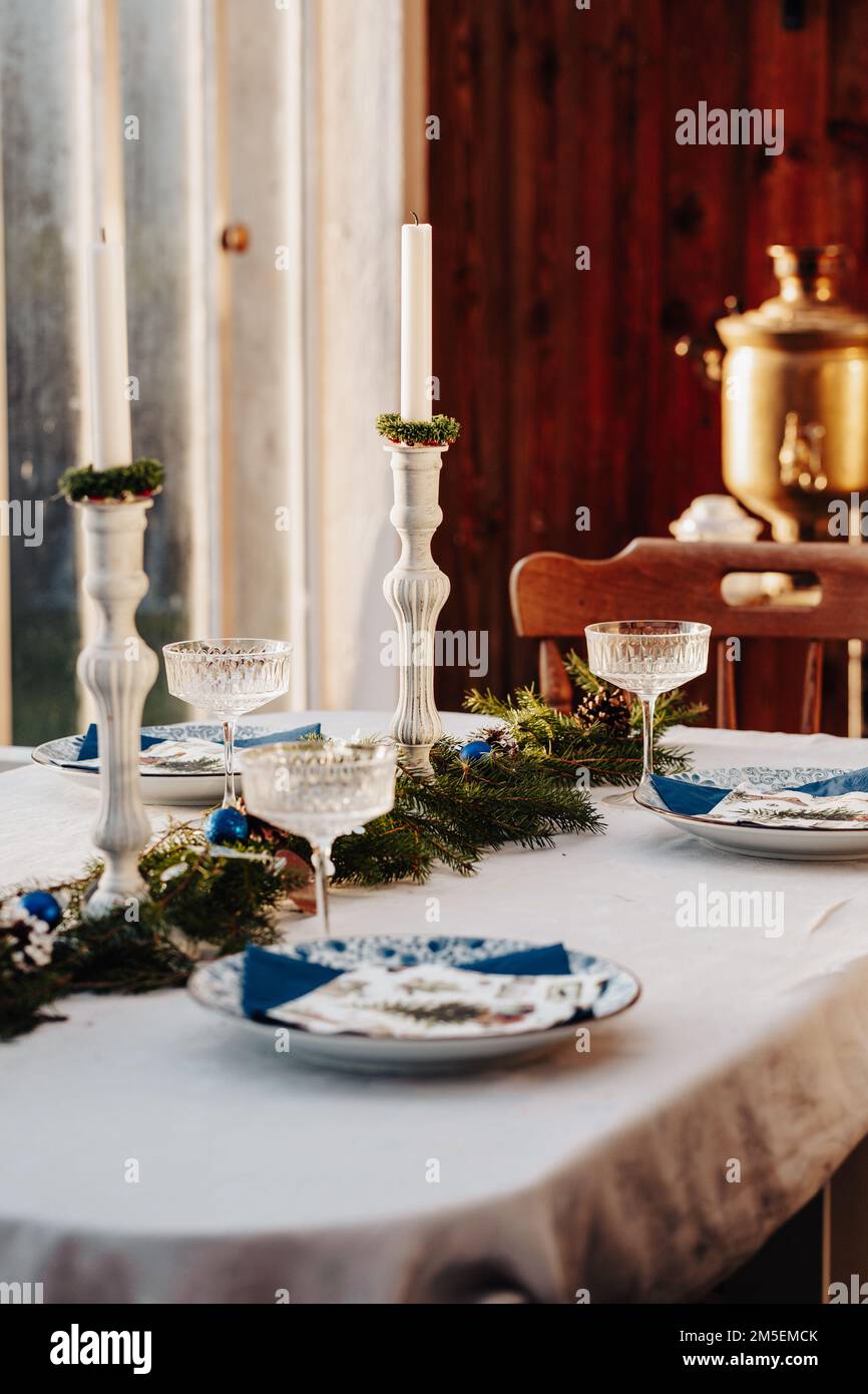 Christmas table setting on the veranda Stock Photo - Alamy