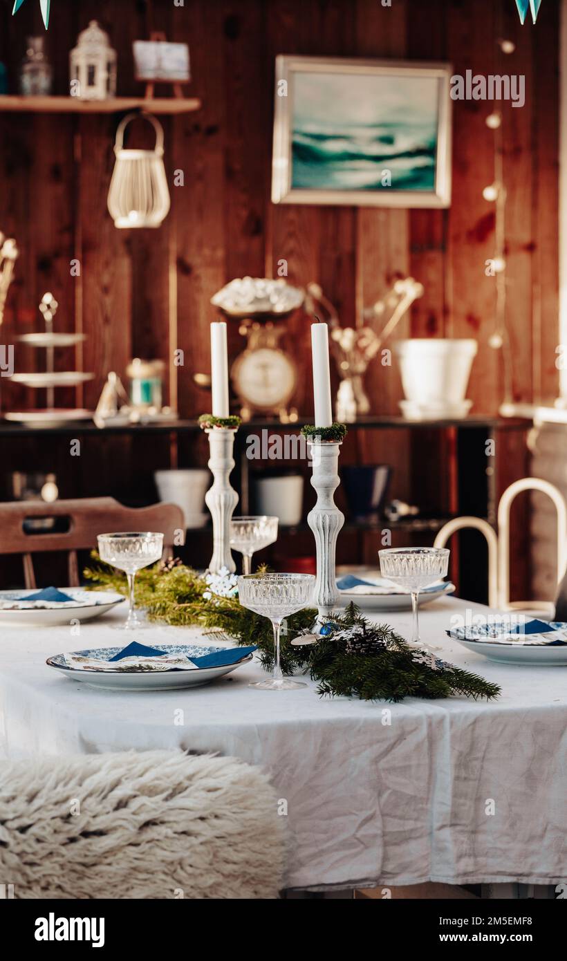 Christmas table setting on the veranda Stock Photo - Alamy