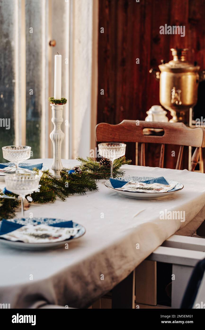 Christmas table setting on the veranda Stock Photo - Alamy