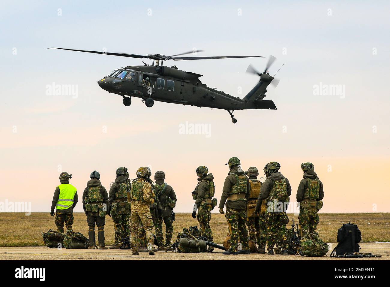 MIHAIL KOGALNICEANU AIR BASE, Romania – Soldiers of the Royal Netherlands 13th Air Assault Battalion,11th Air Assault Brigade prepare to board a 1st Air Cavalry Brigade UH60 Blackhawk during Rapid Falcon, MK Air Base, Romania, March 8, 2022.    Rapid Falcon is designed as a joint multinational exercise to increase operability and joint reaction capacity as well as the development of functional relationships between participating structures. Stock Photo