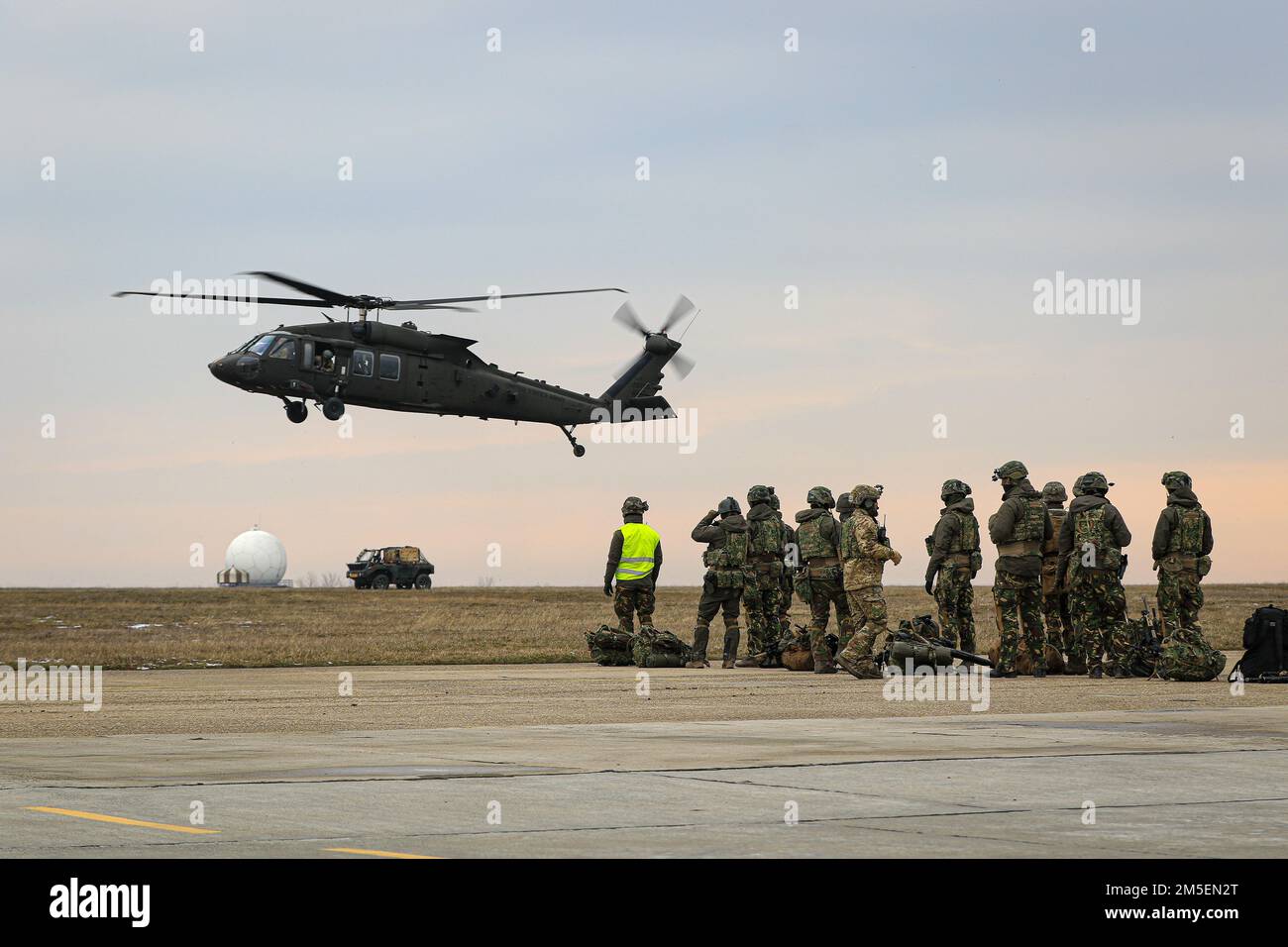 MIHAIL KOGALNICEANU AIR BASE, Romania – Soldiers of the Royal Netherlands 13th Air Assault Battalion,11th Air Assault Brigade prepare to board a 1st Air Cavalry Brigade UH60 Blackhawk during Rapid Falcon, MK Air Base, Romania, March 8, 2022.    Rapid Falcon is designed as a joint multinational exercise to increase operability and joint reaction capacity as well as the development of functional relationships between participating structures. Stock Photo