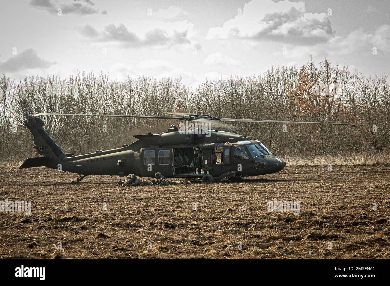MIHAIL KOGALNICEANU AIR BASE, Romania – Soldiers with the Royal Netherlands 13th Air Assault Battalion,11th Air Assault Brigade exit a 1st Air Cavalry Brigade UH60 Blackhawk during Rapid Falcon, Babadag Training Area, Romania, March 8, 2022.     Rapid Falcon is designed as a joint multinational exercise to increase operability and joint reaction capacity as well as the development of functional relationships between participating structures. Stock Photo