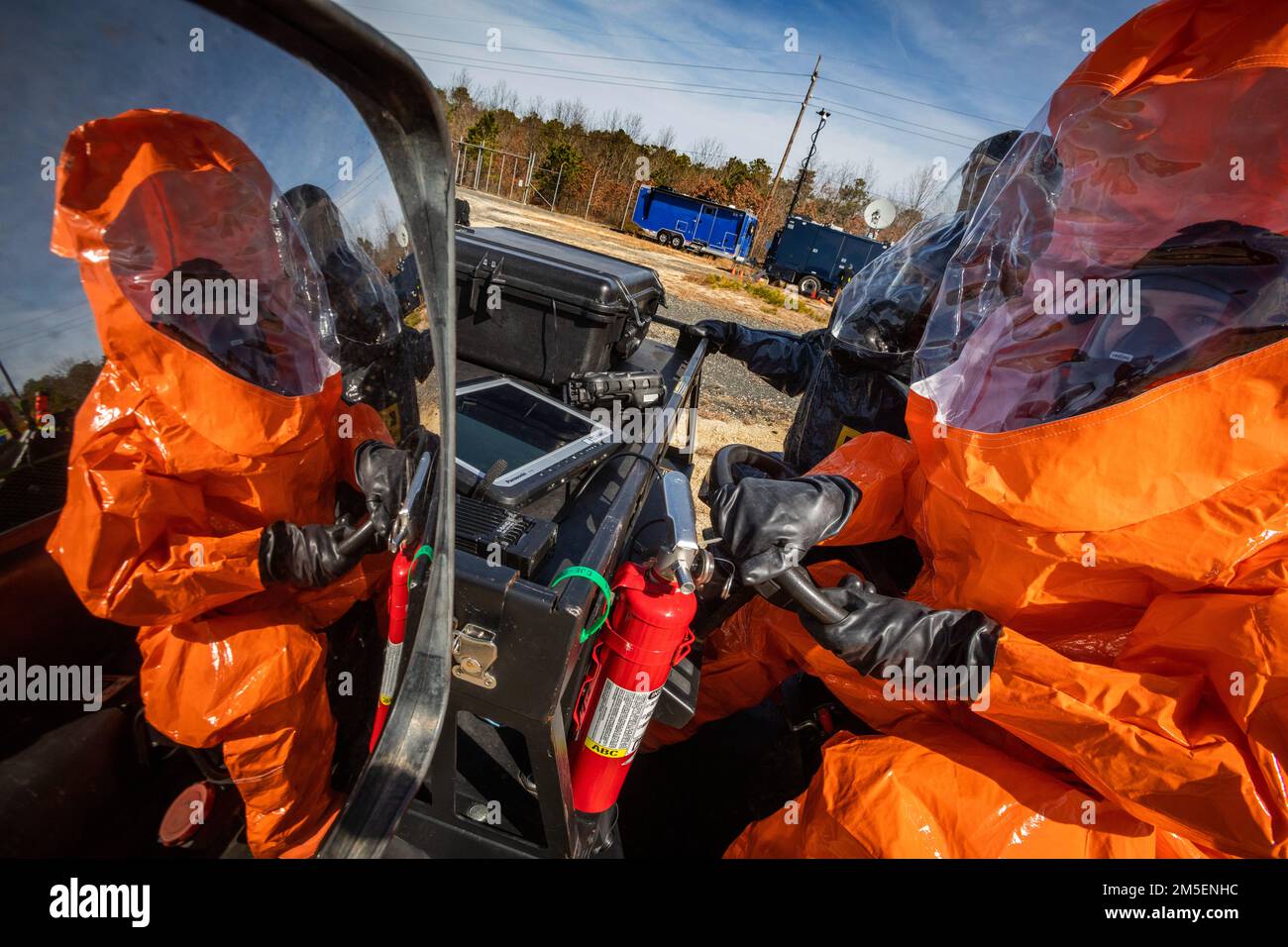 U.S. Air Force Senior Airman Alex J. Potts, right, and Army Sgt. Christopher Mejia, both survey team members with the 21st Weapons of Mass Destruction-Civil Support Team (21st WMD-CST), New Jersey National Guard, prepare to drive to a simulated crime scene during an Army North training exercise at the William J. Hughes Technical Center, Federal Aviation Administration, Egg Harbor Township, New Jersey, March 3, 2022. The 21st identifies chemical, biological, radiological, and nuclear substances; assesses and advises civil authorities on response measures to man-made or natural disasters. (New J Stock Photo