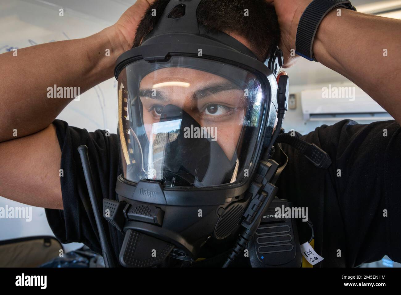 U.S. Army Sgt. Christopher Mejia, survey team member, 21st Weapons of Mass Destruction-Civil Support Team (21st WMD-CST), New Jersey National Guard, dons his self-contained breathing apparatus during an Army North training exercise at the William J. Hughes Technical Center, Federal Aviation Administration, Egg Harbor Township, New Jersey, March 3, 2022. The 21st identifies chemical, biological, radiological, and nuclear substances; assesses and advises civil authorities on response measures to man-made or natural disasters. (New Jersey National Guard photo by Mark C. Olsen) Stock Photo