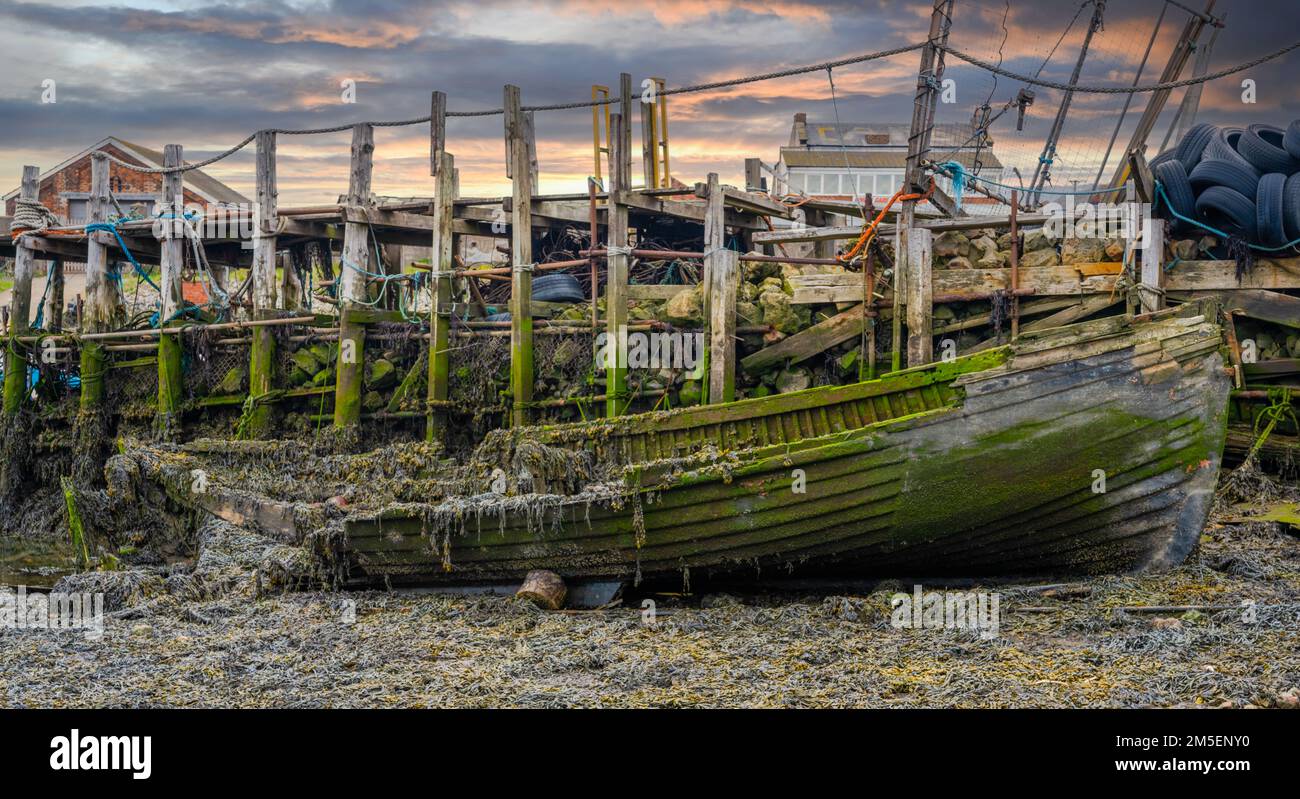 Abandoned and rotting wooden fishing boat in a makeshift harbour Stock ...