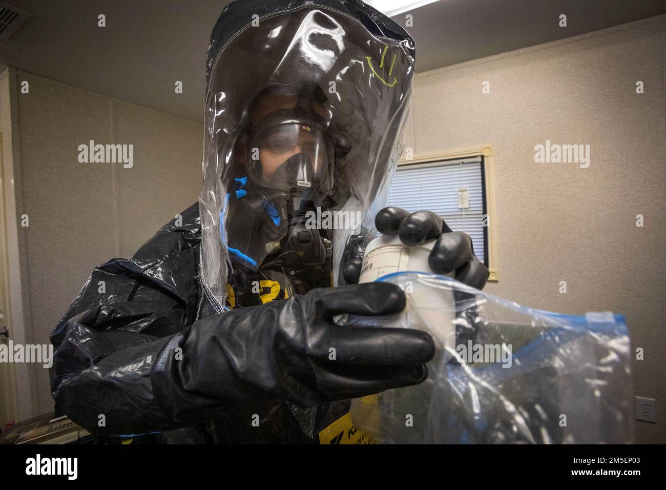 U.S. Army Staff Sgt. Nicky Lam, survey team member with the 21st Weapons of Mass Destruction-Civil Support Team (21st WMD-CST), New Jersey National Guard, packages a sample at a simulated crime scene during an Army North training exercise at the William J. Hughes Technical Center, Federal Aviation Administration, Egg Harbor Township, New Jersey, March 3, 2022. The 21st identifies chemical, biological, radiological, and nuclear substances; assesses and advises civil authorities on response measures to man-made or natural disasters. (New Jersey National Guard photo by Mark C. Olsen) Stock Photo