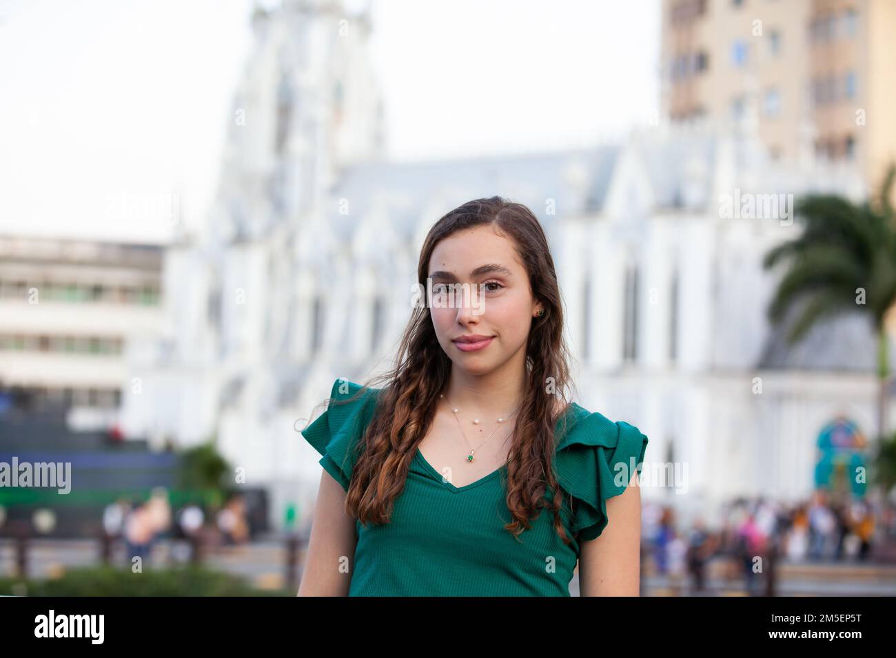Beautiful tourist girl at the Ortiz Bridge with La Ermita church on
